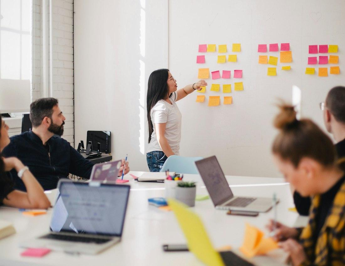 A team planning together around a table with sticky notes