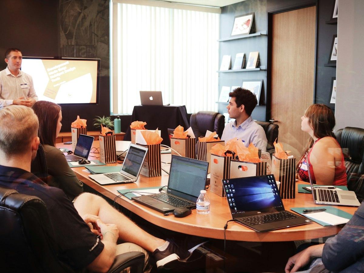 A team workshop with laptops around a meeting table