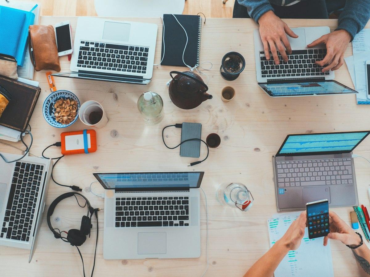 A product team collaborating around laptops