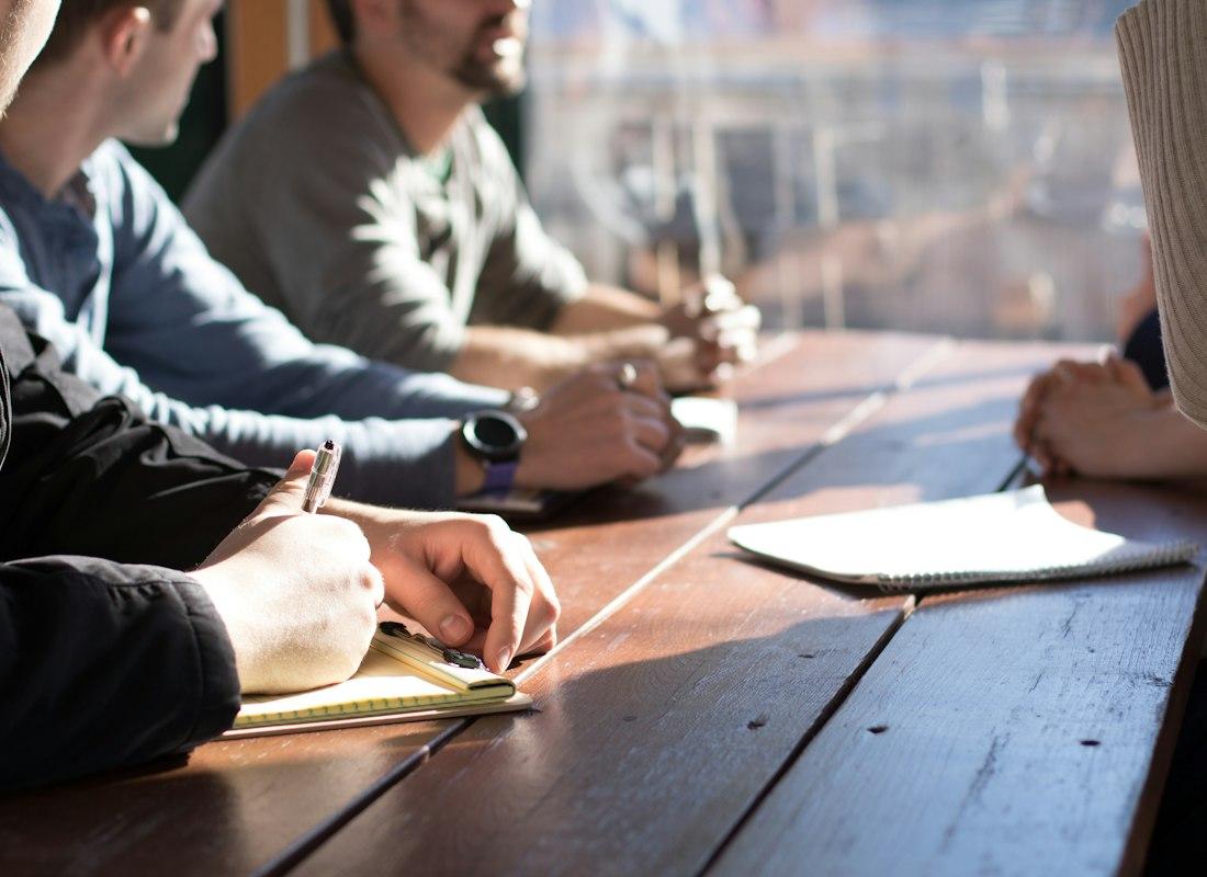 A hiring manager and engineers meeting around laptops